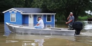 SORRENTO, LA - AUGUST 16: People drive through a flooded road by boat as they visit their neighborhood on August 16, 2016 in Sorrento, Louisiana. Starting last week Louisiana was overwhelmed with flood water causing at least seven deaths and thousands of homes damaged by the flood waters. (Photo by Joe Raedle/Getty Images)