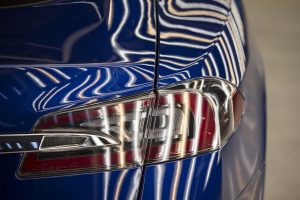 A Tesla Model S automobile stands in a light tunnel during quality control checks ahead of European shipping from the Tesla Motors Inc. factory in Tilburg, Netherlands, on Thursday, Oct. 8, 2015. Tesla said it delivered 11,580 vehicles in the third quarter, meeting its target after Chief Executive Officer Elon Musk handed over the first Model X sport utility vehicles just before the end of the period. Photographer: Jasper Juinen/Bloomberg