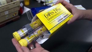 In this Friday, July 8, 2016, photo, pharmacist Clint Hopkins, owner of Pucci's Pharmacy, displays a package of EpiPens, an epinephrine autoinjector for the treatment of allergic reactions, in Sacramento, Calif. Frustrated by the rising cost of prescription drugs, health advocates hope sunlight and a dose of shame might discourage drugmakers from raising their prices too quickly or introducing new medications at prices that break the bank.