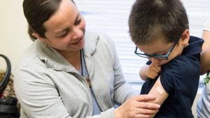 Luz Barajas took her son Carlos Cholico to get his flu shot at Crawford Kids Clinic in Aurora, Colo., last year. Health officials say there is some evidence the flu shot is more protective than the nasal flu vaccine.