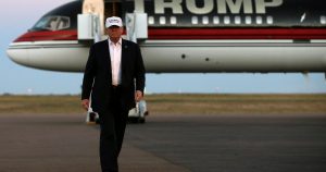 Republican presidential nominee Donald Trump walks off his plane at a campaign rally in Colorado Springs